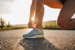 Woman ties running shoe