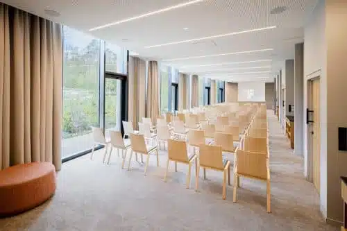 A seminar room with a variety of seating and writing options at LOISIUM Hotel