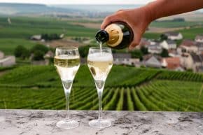 Tasting Of Brut And Demi Sec White Champagne Sparkling Wine From Special Flute Glasses With Champagne Vineyards On Background Near Cramant, France